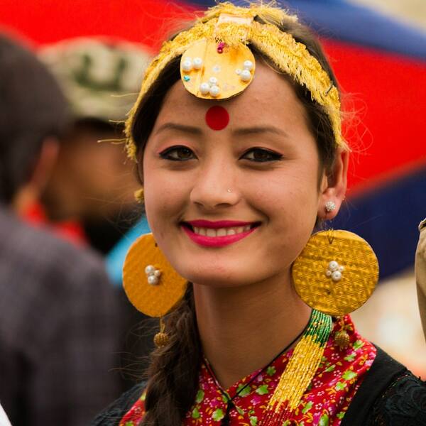 A young woman in traditional Nepali dress and gold jewellery